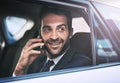 Im just pulling up. a handsome young businessman making a phonecall while being driven to work. Royalty Free Stock Photo