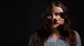 Im just trying to find myself. Studio shot of a woman posing against a dark background with a distorted face.