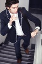 Im late. A young man realising hes late while walking up the stairs. Royalty Free Stock Photo