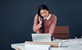 Im looking at your latest designs right now. an attractive young female architect making a phone call while working in Royalty Free Stock Photo