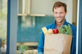 Im making the healthy choice. Portrait of a happy man holding a bag full of healthy groceries. Royalty Free Stock Photo