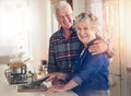 Im making his favourite. Portrait of a senior couple cooking together in their kitchen at home. Royalty Free Stock Photo