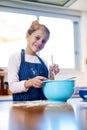 Im making some super tasty treats. Portrait of a little girl baking in the kitchen at home. Royalty Free Stock Photo