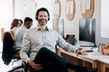 Im the manager on duty. a mature businessman sitting in the office and wearing a headset while his colleagues work Royalty Free Stock Photo