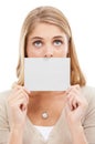 Im mum about this. Studio shot of a woman holding a blank sign in front of her mouth isolated on white. Royalty Free Stock Photo