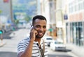 Im on my way there...A handsome african american businessman on his mobile while out in the city. Royalty Free Stock Photo