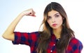 Im not just a woman, Im a strong woman. Cropped shot of a young woman flexing her muscles against a white background.