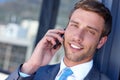 Im only a phone call away. a handsome young businessman talking on his mobile phone at work. Royalty Free Stock Photo