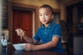 Im a picky eater but not when it comes to spaghetti. a young boy eating a bowl of spaghetti at home. Royalty Free Stock Photo