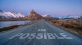 im possible text quote printed on asphalt road towards the mountains