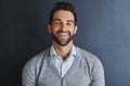 Im proud of all my achievements. Portrait of a handsome young businessman posing against a dark background. Royalty Free Stock Photo