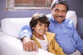 Im so proud of my grandson. Portrait of a smiling grandfather and grandson sitting on a sofa at home. Royalty Free Stock Photo