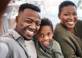 Im the proudest dad in the world. Shot of a happy young family taking selfies on the sofa at home. Royalty Free Stock Photo