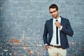 Im ready to do business. Cropped portrait of a handsome young businessman adjusting his tie while standing against a Royalty Free Stock Photo