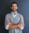 Im ready to head to the top. Portrait of a handsome young businessman posing against a dark background. Royalty Free Stock Photo