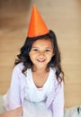 Im ready, wheres the party. Portrait of a cute little girl wearing a party hat at home.