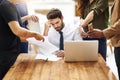 Im seriously so stressed out right now. Cropped shot of a stressed out businessman surrounded by colleagues needing help