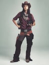 Im the sheriff around these parts...Full-length shot of an attractive young woman in cowboy attire. Royalty Free Stock Photo