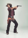 Im the sheriff around these parts...Full-length shot of an attractive young woman in cowboy attire. Royalty Free Stock Photo