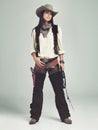 Im the sheriff around these parts...Full-length shot of an attractive young woman in cowboy attire. Royalty Free Stock Photo