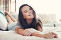 Im smiling because Im comfortable. Portrait of an attractive young woman spending a relaxing day on her bed at home. Royalty Free Stock Photo