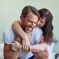 Im sorry but Im not letting go. a cheerful young couple embracing each other with a hug while relaxing on the bed at Royalty Free Stock Photo