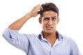 Im stumped. A handsome young man scratching his head in confusion against a white background. Royalty Free Stock Photo