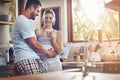 Im so sure the coffee makes me a better person. a couple standing together in their kitchen.