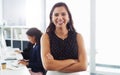 Im a take charge leader. Portrait of a confident young businesswoman working in a modern office with her colleague in Royalty Free Stock Photo