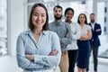 Im so thankful for an amazing team behind me. Portrait of a businesswoman standing in an office with her colleagues in Royalty Free Stock Photo