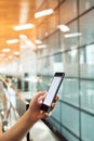 Im about to board...an unrecognizable woman sending a text while standing in an airport. Royalty Free Stock Photo