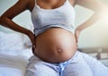 Im about to pop. a pregnant young woman relaxing on the bed at home. Royalty Free Stock Photo