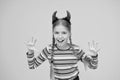 Im too cute to spook. Small child dressed for Halloween party. Little girl wear Halloween red devil horns. Have Royalty Free Stock Photo