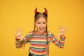 Im too cute to spook. Small child dressed for Halloween party. Little girl wear Halloween red devil horns. Have Royalty Free Stock Photo