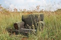 ABANDONED UPHOLSTERED CHAIR IN A FIELD WITH LONG GRASS Royalty Free Stock Photo