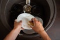 Image from above of man`s hands washing the dish into sink Royalty Free Stock Photo