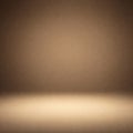This image is an abstract background featuring a gradient of brown tones. A brighter, spotlight-like area appears at the bottom Royalty Free Stock Photo