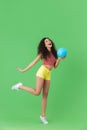 Image of active woman 20s wearing summer clothes smiling and holding volley ball Royalty Free Stock Photo