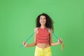 Image of active woman 20s wearing summer clothes working out and doing exercises with jumping rope Royalty Free Stock Photo