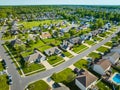 Aerial neighborhood with bright green summer lawns