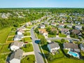 Aerial neighborhood with pools in yards and cars in driveways