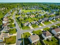 Aerial neighborhood on warm summer day with green lawns