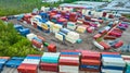 Aerial stacked walls of metal shipping crates in container yard