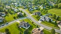 Aerial suburban neighborhood fresh cut green lawns middleclass housing addition