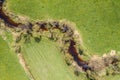 Image of aerial view of naturally meandering stream river kleine Ohe with trees on bank surrounded by green fields meadows in Bava