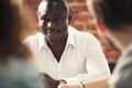 Image of African-American business leader looking at camera in working environment. Royalty Free Stock Photo