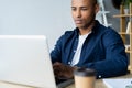 Image of african american businessman working on his laptop. Handsome young man at his desk Royalty Free Stock Photo