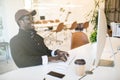 Portrait of african american businessman working on his laptop. Handsome young man at his desk Royalty Free Stock Photo