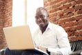 Image of african american businessman working on his laptop. Handsome young man at his desk Royalty Free Stock Photo