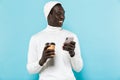 Image of african american guy holding cellphone and takeway coffee cup Royalty Free Stock Photo